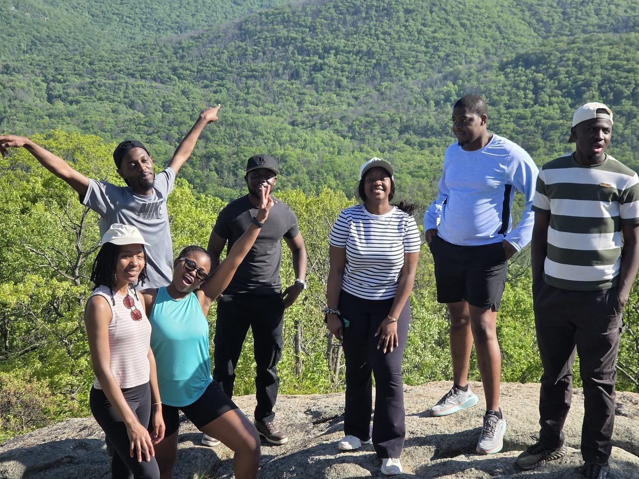 MAGIS hikers celebrating together on a rock overlook