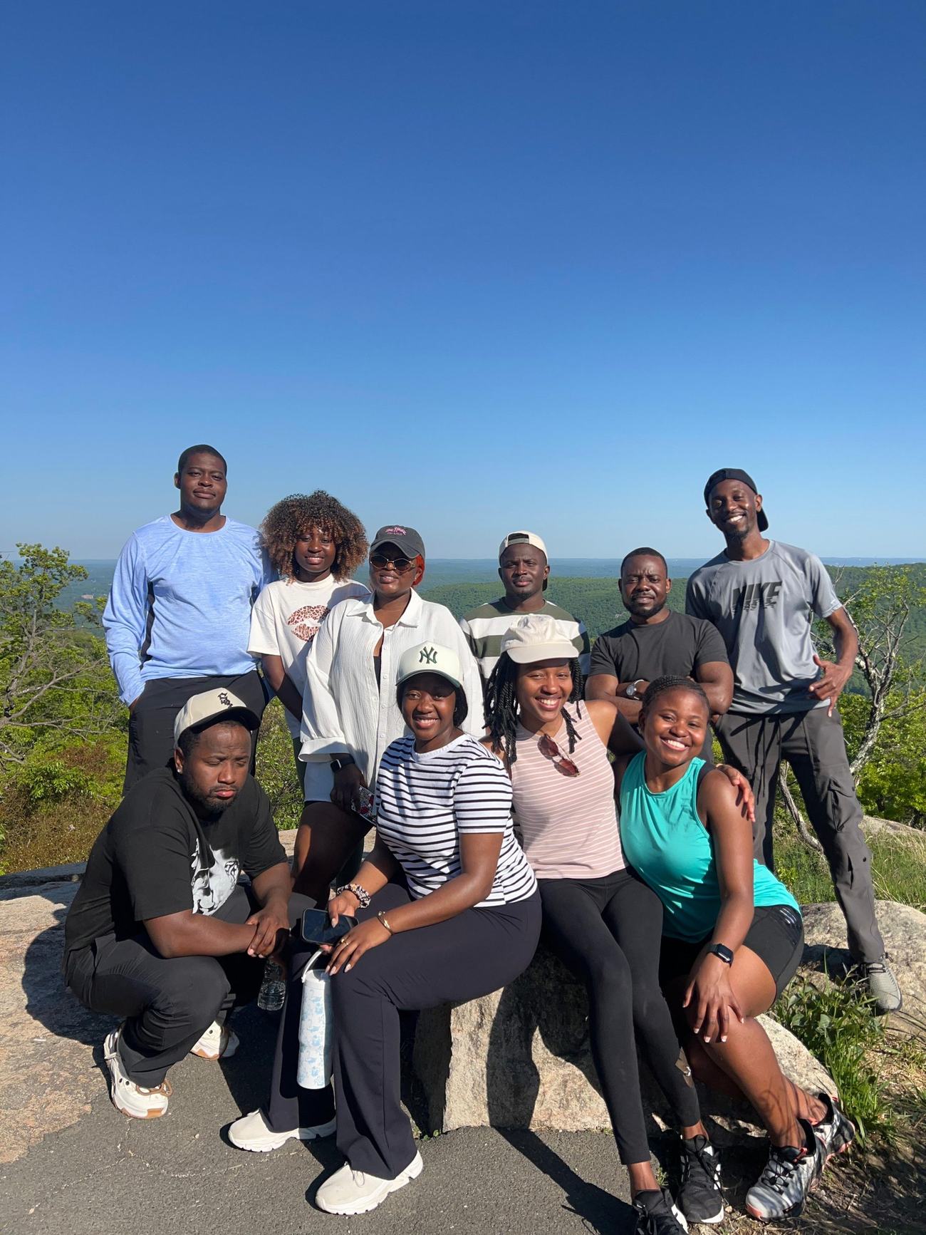 MAGIS members smiling together at a sunny mountain overlook